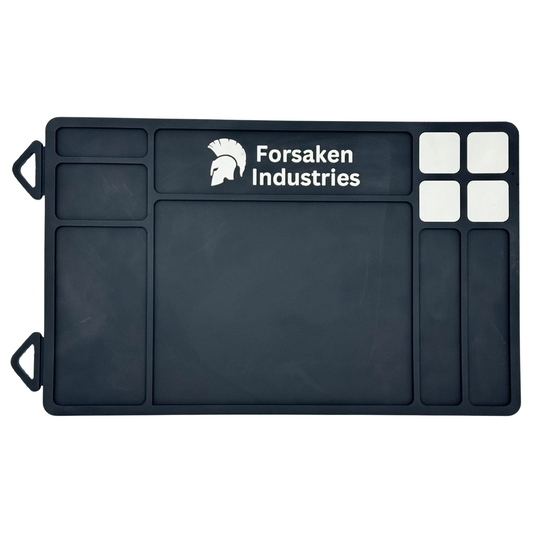 Forsaken Industries magnetic gun cleaning mat with built-in magnets during real firearm maintenance.