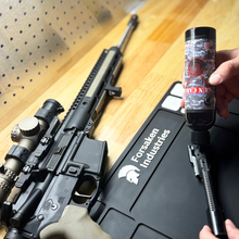 Applying Forsaken Industries CLP 8oz squeeze bottle to AR-15 bolt carrier group for deep cleaning and lubrication