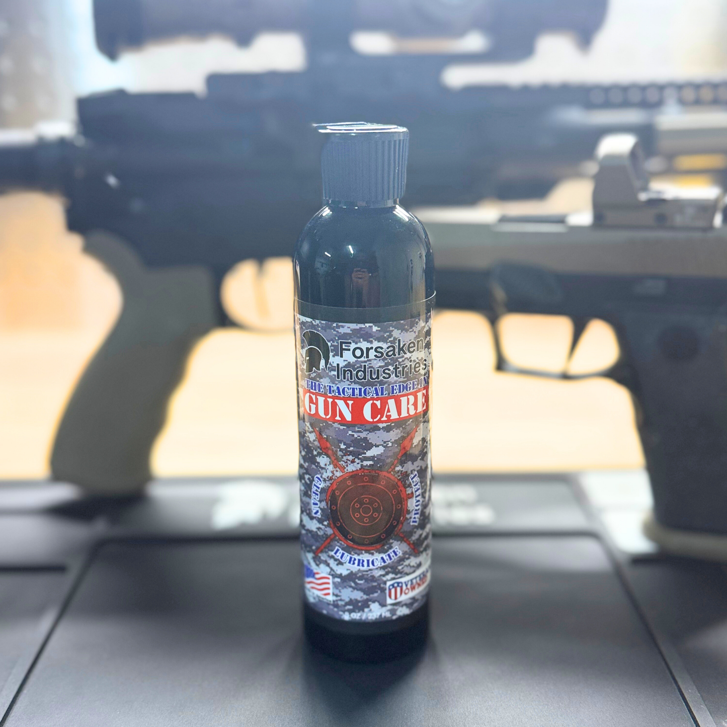 Forsaken CLP 8oz squeeze bottle gun cleaner, lubricant, and protectant on workbench with rifle