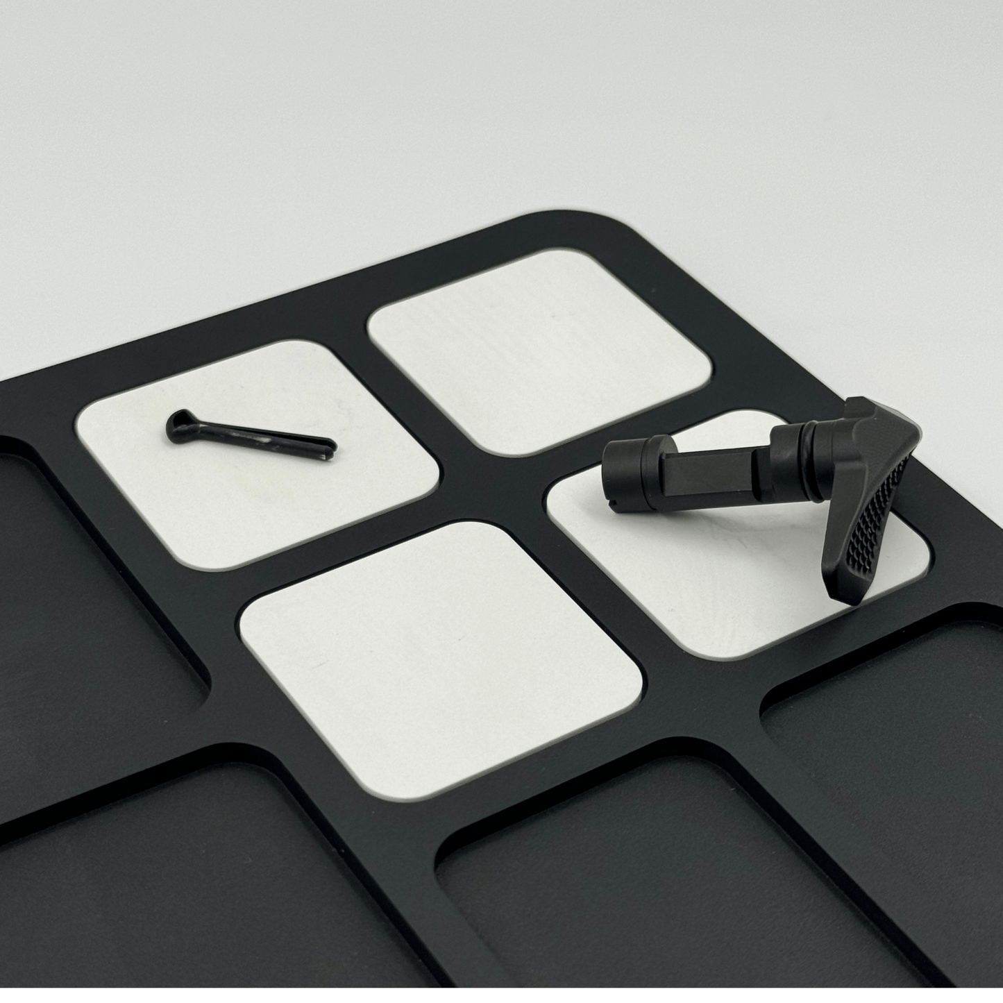 Forsaken Industries Magnetic Gun Cleaning Mat securing small firearm components during maintenance