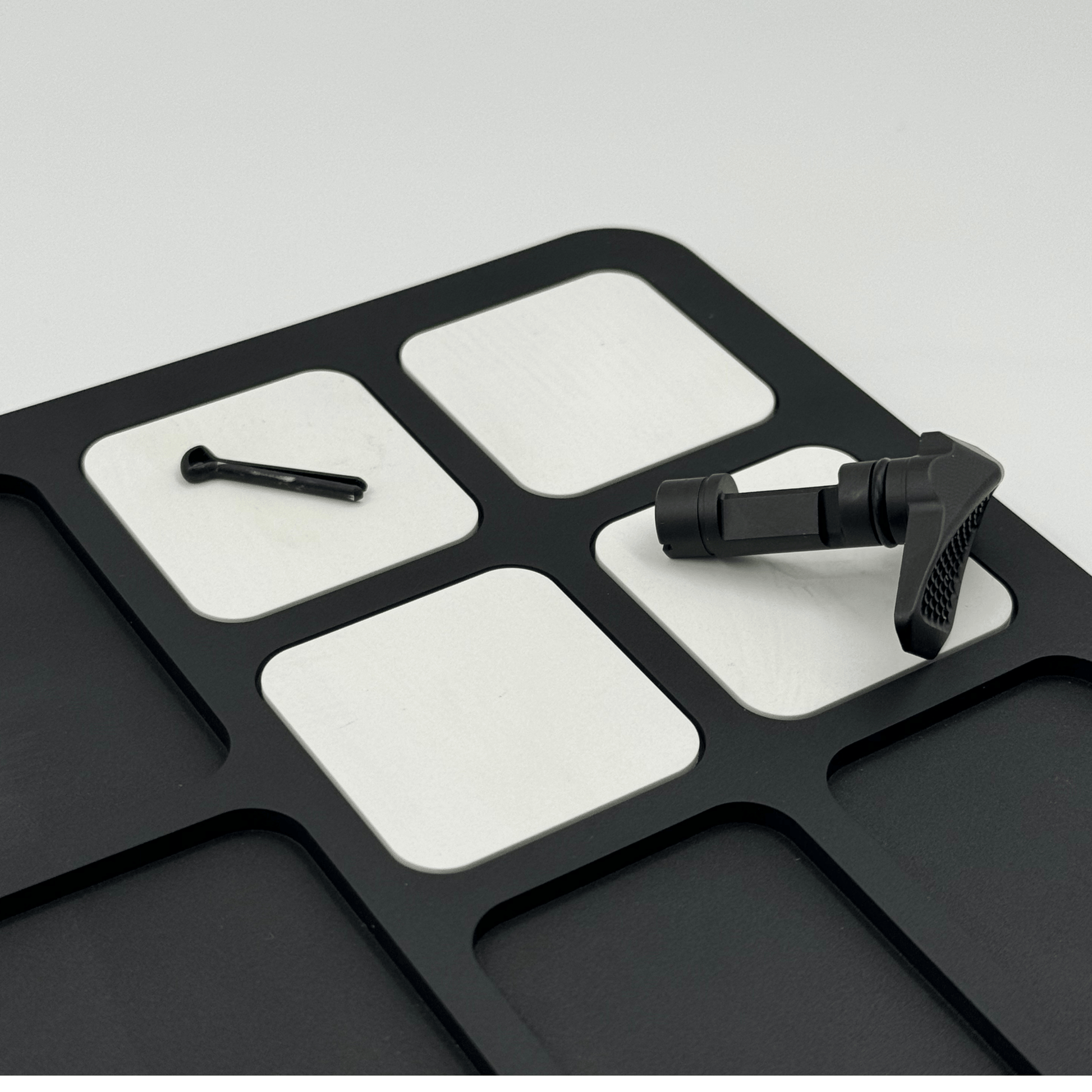 Forsaken Industries Magnetic Gun Cleaning Mat securing small firearm components during maintenance